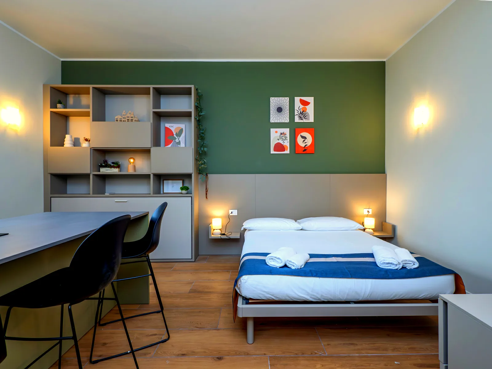 Sleeping area at Meazza Suite: double bed, open shelving and work surface